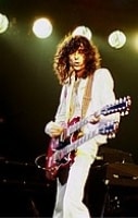 Rock And Roll Hall Of Fame - A Photo of Jimmy Page playing a double neck guitar.