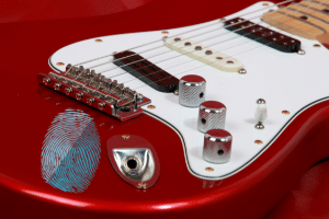 An electric guitar with a fingerprint on it