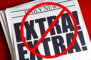A newspaper that says "no extras"