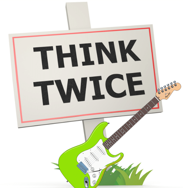 Stratocaster Tremolo Setup – A guitar in front of a sign that says "Think Twice"