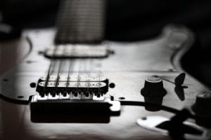 Why Change Guitar Strings - A photo of a Stratocaster guitar in  black and white