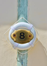 Guitar Repair Maintenance Kit – A life preserver hanging on a post with the number 8 in the middle