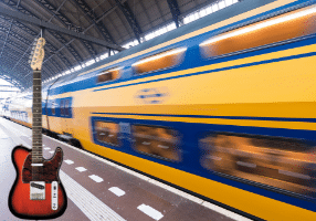 Learning Guitar Solos - A photo of a fast-moving train with an electric guitar standing on the platform
