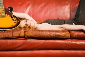 Best Couch Guitar - A girl sleeping on the couch with her guitar