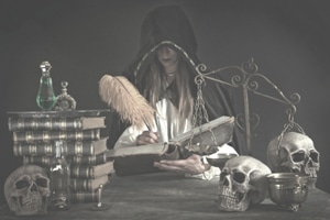 Learn To Play A Guitar Fast - A woman writing a magic incantation in her book of spells.