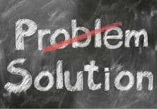 Learn To Play A Guitar Fast – A blackboard with the word "problem" crossed out and the word "solution" written below it.