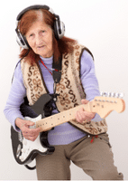 Learning Guitar For Seniors - An elderly woman playing an electric guitar.