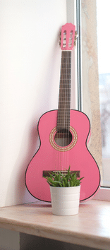 Learning Guitar For Seniors - An acoustic guitar on a countertop