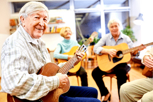Guitar Tips For Beginners - A group of senior citizens playing guitar together.