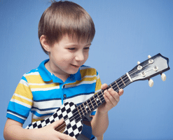 Guitar Tips For Beginners - A little child learning to play the guitar.