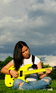 Relax When Playing Guitar – A woman playing an electric guitar outside