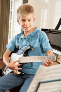 Relax When Playing Guitar – A young boy playing an electric guitar