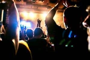 Where Did Heavy Metal Originate - A photo of an audience cheering on a heavy metal band.
