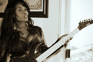 Where Did Heavy Metal Originate - A photo of a female metal guitar player.