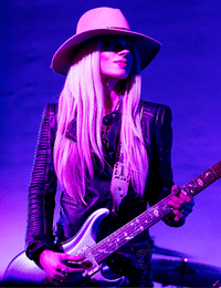 Female Rock Guitar Players – Orianthi, playing her guitar onstage.