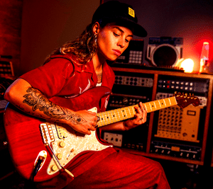 Fender Tash Sultana Stratocaster - Tash sitting in a recording studio and playing her signature guitar.