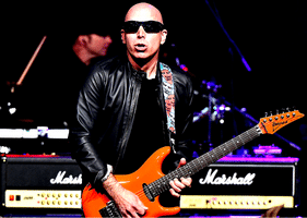 Reduce Guitar String Noise – Joe Satriani playing onstage.