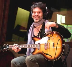 Can You Change A Right Handed Guitar To Left Handed - Doyle Bramhall II playing a guitar turned upside down.