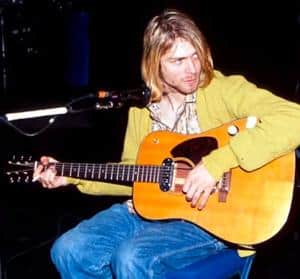 Can You Change A Right Handed Guitar To Left Handed - Kurt Cobain playing an acoustic guitar.