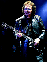 Can You Change A Right Handed Guitar To Left Handed - Tony Iommi playing his guitar on stage.