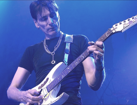 Is Playing A Guitar A Talent Or Skill - Steve Vai playing an electric guitar