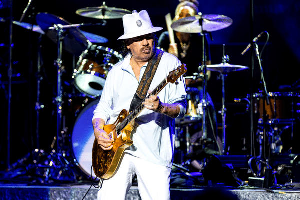 What Makes A Guitarist Unique - Carlos Santana playing guitar on stage