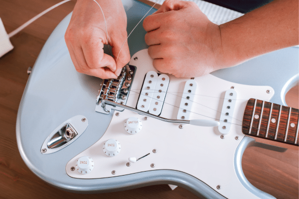 Why Are Some Guitars Easier To Play - An electric guitar being restrung.